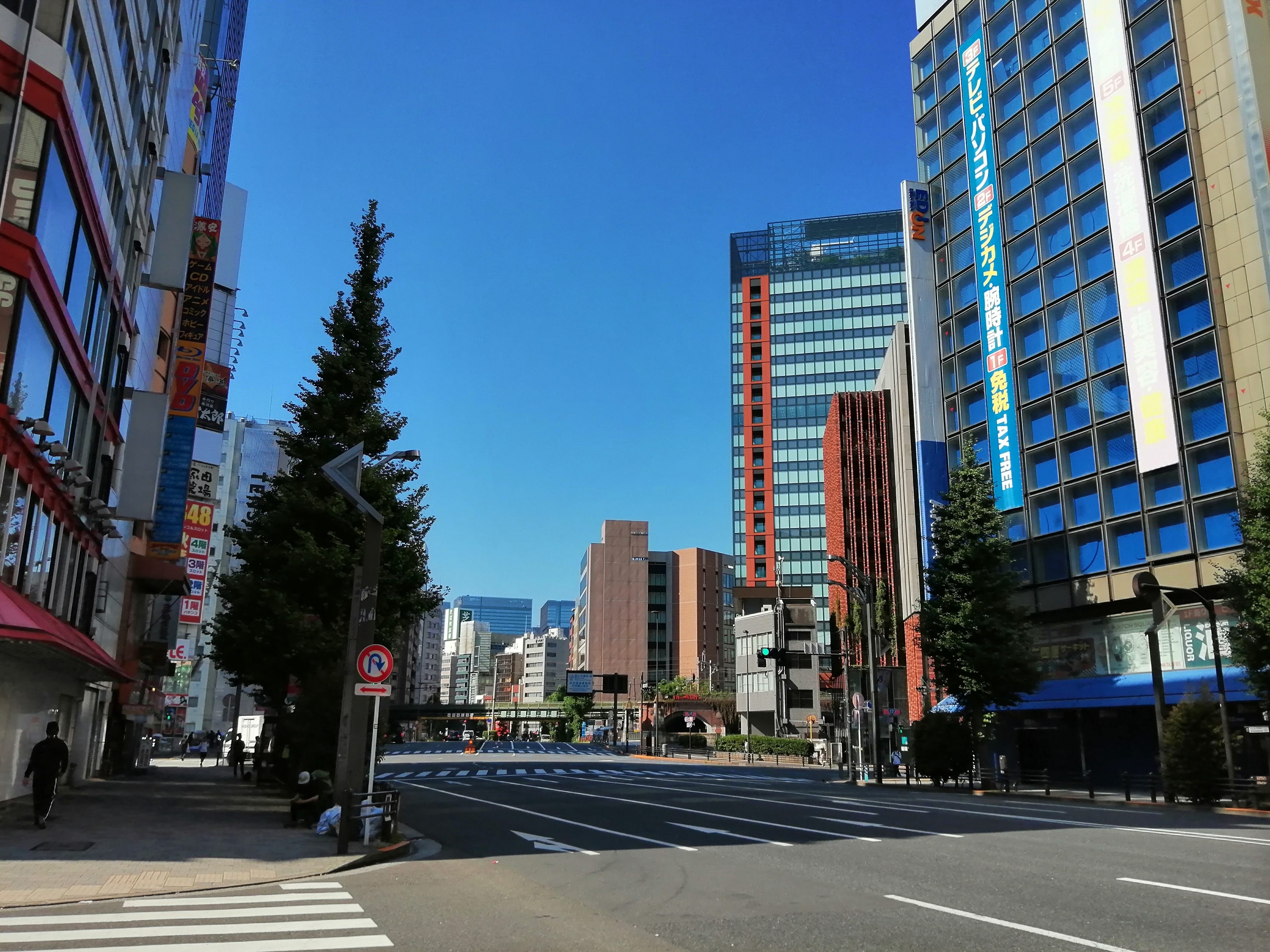 Wide urban road with tall buildings