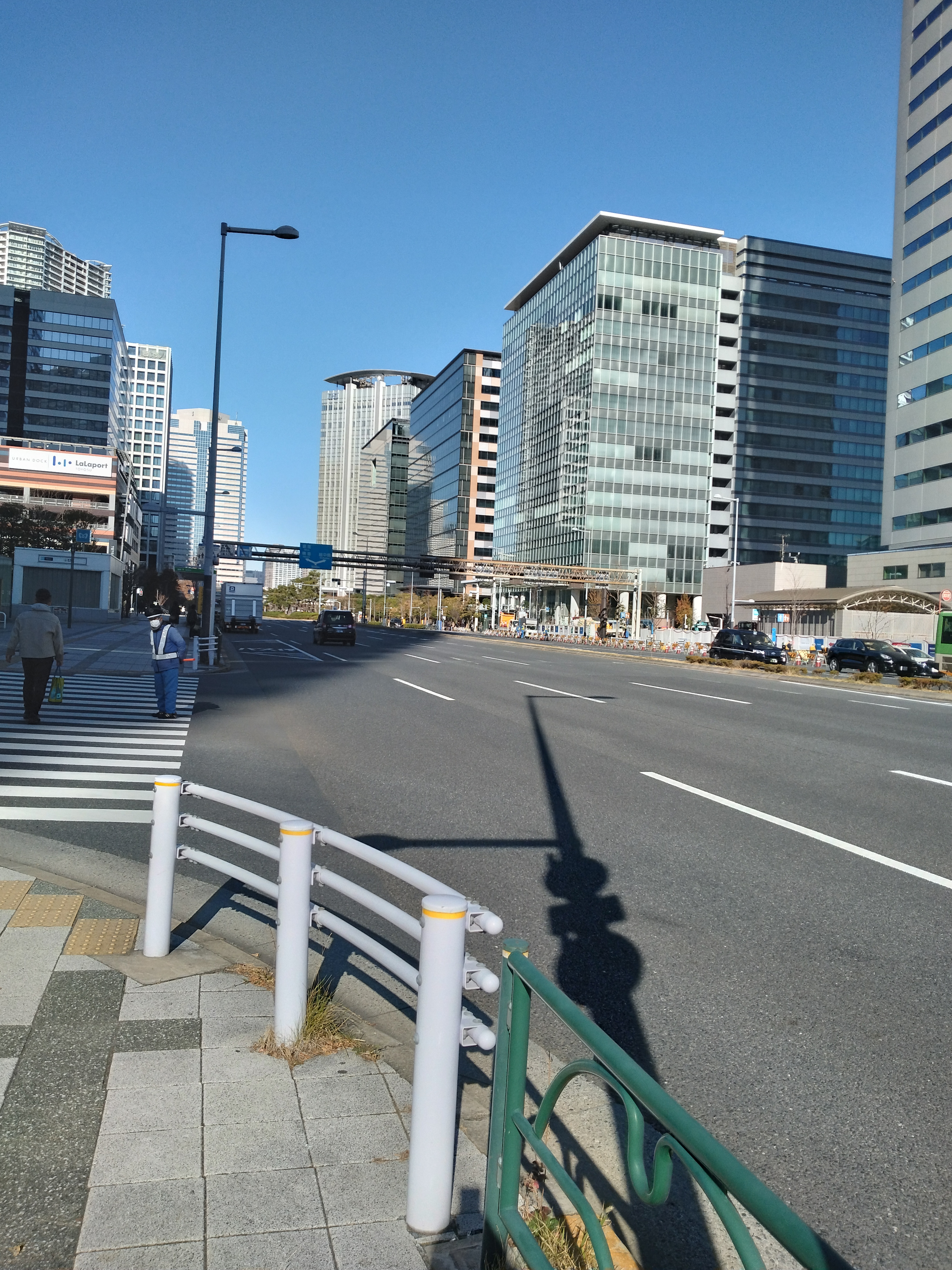 直線的な道路と周囲に立ち並ぶ高層ビルが写っています。